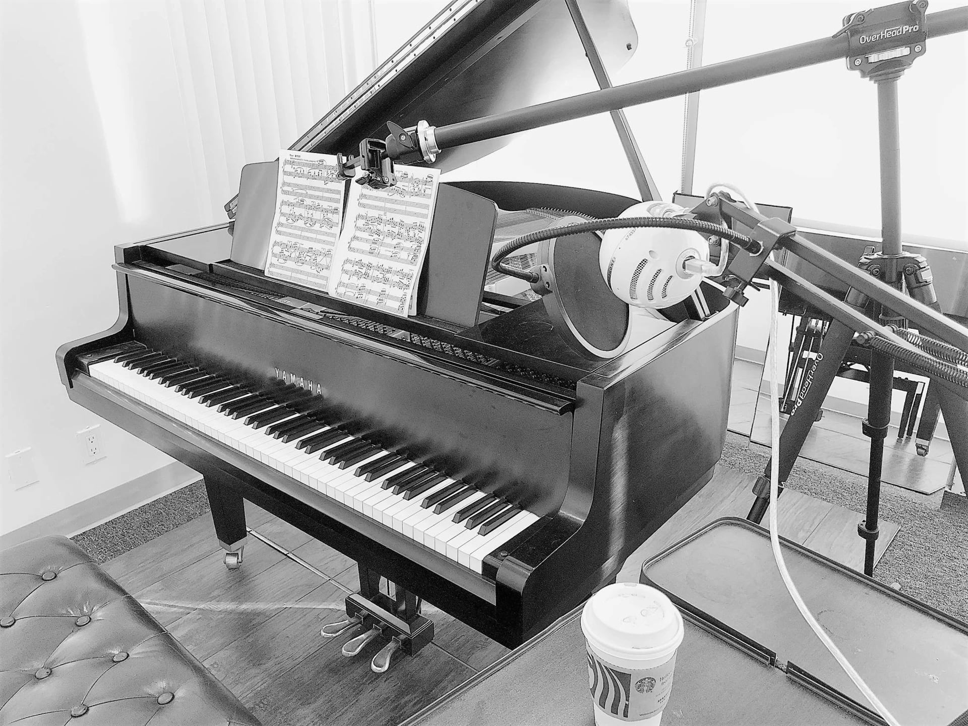 Yamaha grand miked for a session, music on the stand